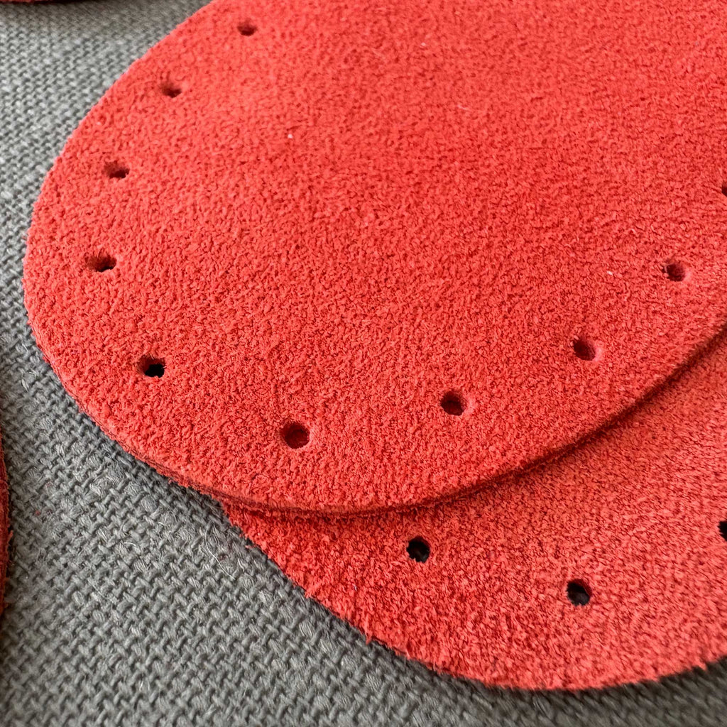 Coral red suede oval patches in three sizes.